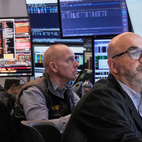 Traders Michael Urkonis, left, and Fred Demarco work on the floor of the New York Stock Exchange, Tuesday, Dec. 2, 2025. (AP Photo/Richard Drew)
