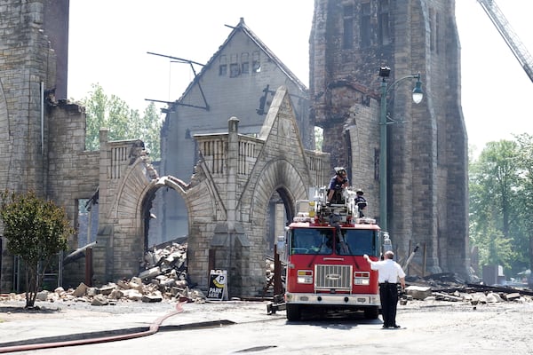 FILE - Firefighters gather outside the historic Clayborn Temple, a landmark from the civil rights movement with ties to Martin Luther King Jr., after it caught fire, April 28, 2025, in Memphis, Tenn. (AP Photo/Karen Pulfer Focht, File)