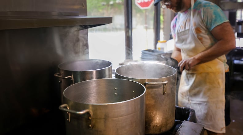 Line cook William Miracle works in the kitchen next to large pots that are boiling water on June 3 at Sun in my Belly in the Kirkwood neighborhood of Atlanta. (Jason Getz/The Atlanta Journal-Constitution)
