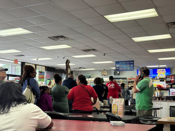 People line up inside a gas station to purchase lottery tickets on Saturday, Aug. 30, 2025, in Tallapoosa. Although the 24-hour gas station is in Georgia, Alabama license plates adorned the vast majority of cars in the parking lot. (Caleb Groves/AJC)