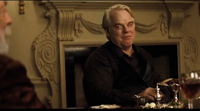 This scene from “Catching Fire,” featuring Donald Sutherland, left, and Philip Seymour Hoffman, was filmed in the dining room of Atlanta’s elegant Swan House.