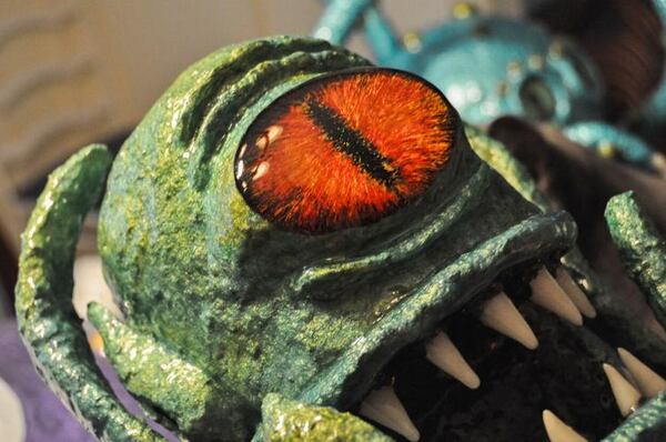 Jeff Fibus’ monster sculpture is made with papier-mache and epoxy resin. The eye is a clear cabachon with nail polish painted in layers. Fibus has been working on his sculptures for around two years.
