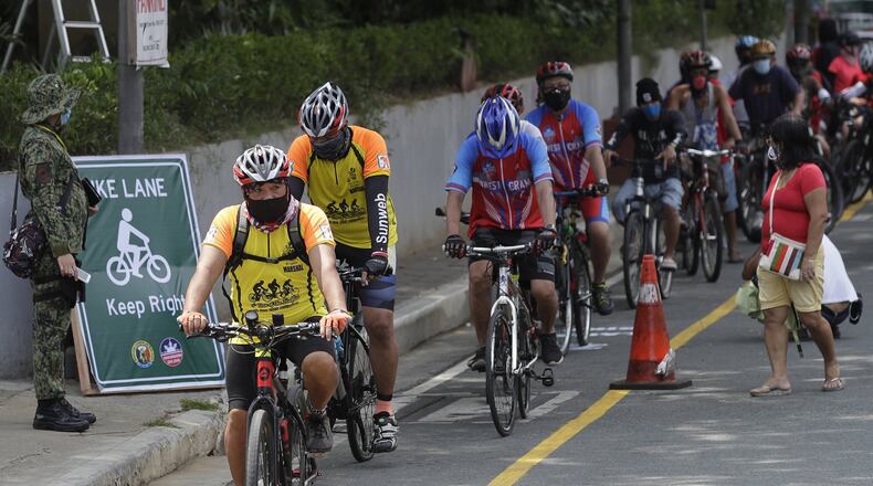 Cyclists wearing protective masks on a newly opened bicycle lane in Manila, Philippines in observance of World Bicycle Day on Wednesday, June 3, 2020. Several cities opened bicycle lanes as people use different ways of commuting while public transport remains limited during a more-relaxed lockdown to prevent the spread of coronavirus. (AP Photo/Aaron Favila)