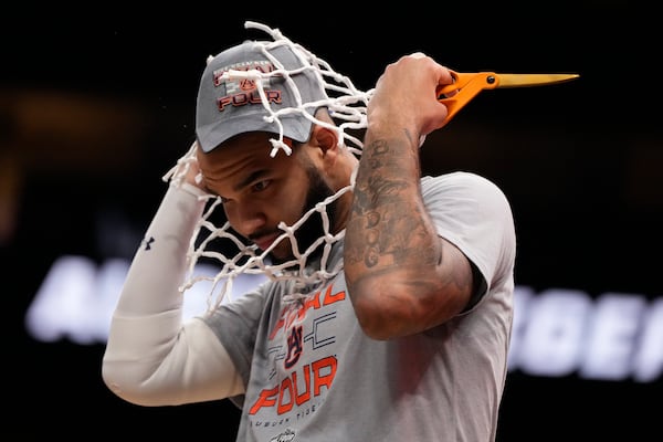 Auburn forward Johni Broome wears the net after the Elite Eight of the NCAA college basketball tournament Michigan State, Sunday, March 30, 2025, in Atlanta. (AP Photo/Brynn Anderson)