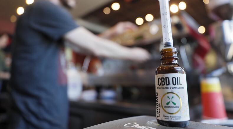 Jason Hoover, barista, prepares espresso drinks at Rev Coffee in Smyrna, which offers a CBD oil latte as well as the option to add it to any beverage. Cannabidiol oil products are gaining in popularity. They use a syringe to measure 10 ml shots. Bob Andres / bandres@ajc.com