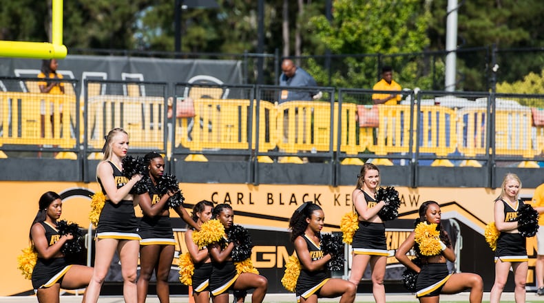 Five KSU cheerleaders take a knee during the national anthem prior to the matchup between Kennesaw State and North Greenville, Saturday, Sept. 30, 2017. (Special to AJC/by Cory Hancock)