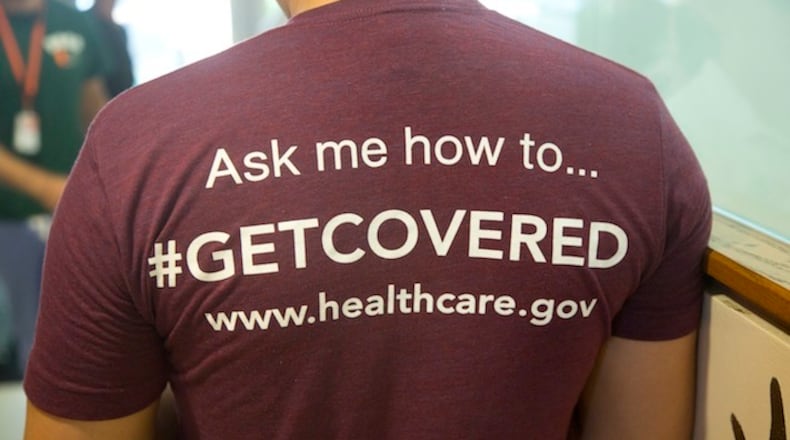 FILE - In this March 15, 2014 file photo,a volunteer health care worker wears a t-shirt, getting people to sign up for the new health care programs, in Miami. Most young Americans want any health care overhaul under President Donald Trump to look a lot like the Affordable Care Act signed into law by his predecessor, President Barack Obama. But there's one big exception: A majority of young Americans dislike "Obamacare's" requirement that all Americans buy insurance or pay a fine. (AP Photo/J Pat Carter, File)