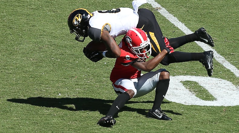 Georgia Bulldogs cornerback Shaq Wiggins (6) tackles Missouri Tigers running back Marcus Murphy (6) for a short gain during Georgia's loss to Missouri at Sanford Stadium Saturday afternoon in Athens, Ga., October 12, 2013. Missouri defeated Georgia 41-26. JASON GETZ / JGETZ@AJC.COM