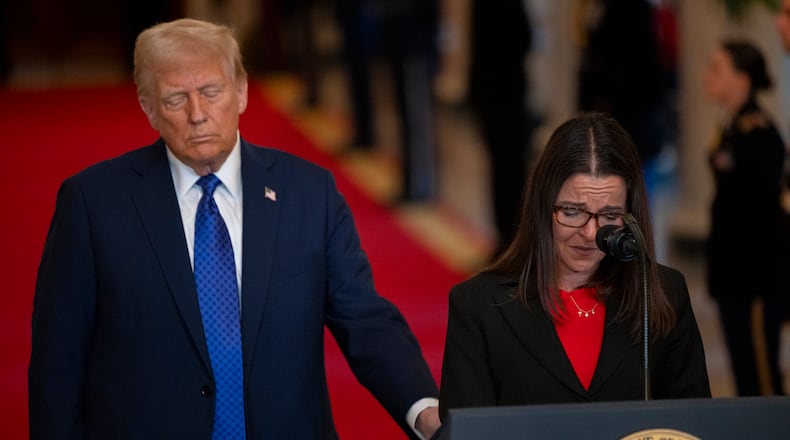 President Donald Trump listens as Allyson Phillips, mother of Laken Riley, speaks before he signs the Laken Riley Act in the East Room of the White House on Wednesday, Jan. 29, 2025, in Washington. (Nathan Posner for the Atlanta Journal-Constitution)