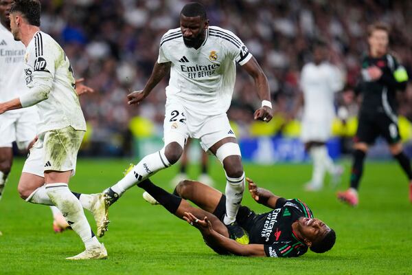 Real Madrid's Antonio Ruediger steps on Arsenal's Myles Lewis-Skelly, on the ground, during the Champions League quarterfinals second leg soccer match between Real Madrid and Arsenal at the Santiago Bernabeu stadium in Madrid, Wednesday, April 16, 2025. (AP Photo/Manu Fernandez)
