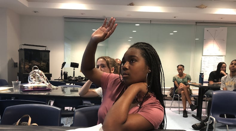 Kierstyn Kirkland asks questions about coral during orientation Monday, June 10 at the Georgia Aquarium. She and nine other students will be traveling to Belize later this month on a study trip to learn about conserving marine species. ARLINDA SMITH BROADY/AJC