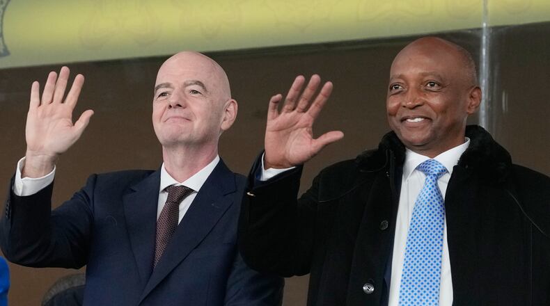 FILE - CAF President Patrice Motsepe and FIFA President Gianni Infantino wave from the tribune during the Africa Cup of Nations round of 16 soccer match between South Africa and Cameroon in Rabat, Morocco, Sunday, Jan. 4, 2026. (AP Photo/Themba Hadebe, File)