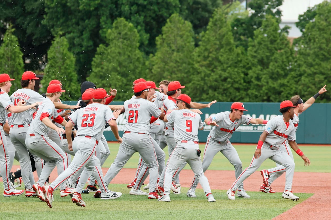 Georgia players celebrate after winning their NCAA super regional series over Mississippi State on Sunday, June 7, 2026, in Athens. The Bulldogs come into the College World Series as the No. 3 seed, the highest-remaining seed still playing. (Miguel Martinez/AJC)