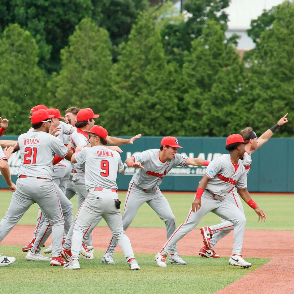 Georgia players celebrate after winning their NCAA super regional series over Mississippi State on Sunday, June 7, 2026, in Athens. The Bulldogs come into the College World Series as the No. 3 seed, the highest-remaining seed still playing. (Miguel Martinez/AJC)