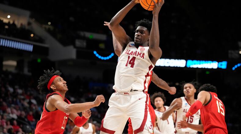 FILE - Alabama center Charles Bediako (14) pulls down a rebound while guarded by Maryland guard Ian Martinez, left, during the second half of a second-round college basketball game in the men's NCAA Tournament in Birmingham, Ala., March 18, 2023. (AP Photo/Rogelio V. Solis, File)