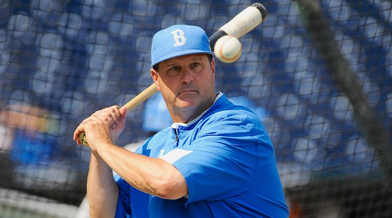 FILE - In this June 14, 2013, file photo, UCLA coach John Savage eyes the ball during NCAA college baseball practice at TD Ameritrade Park in Omaha, Neb. (AP Photo/Eric Francis, File)