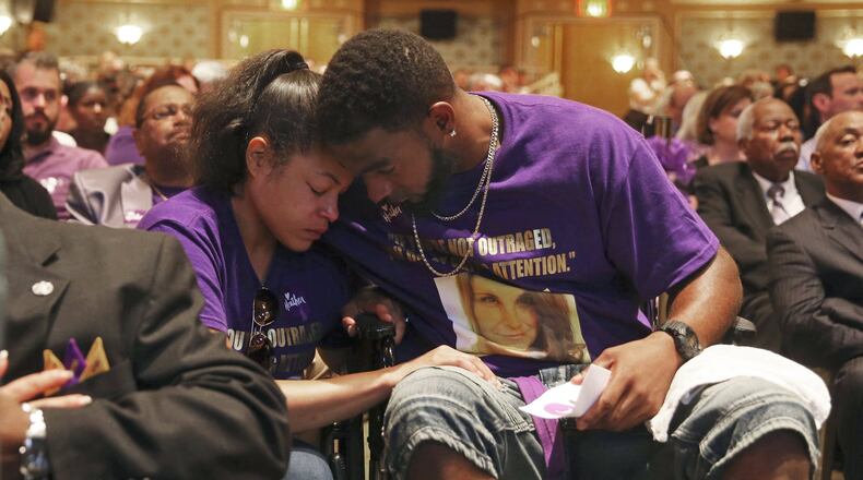 Marcus Martin (right) hugs his fiancee, Marissa Blair, during a memorial for Heather Heyer on Wednesday at the Paramount Theater in Charlottesville, Va. Martin pushed his fiance out of the way of the vehicle that killed Heyer last Saturday. ANDREW SHURTLEFF / THE DAILY PROGRESS VIA AP, POOL