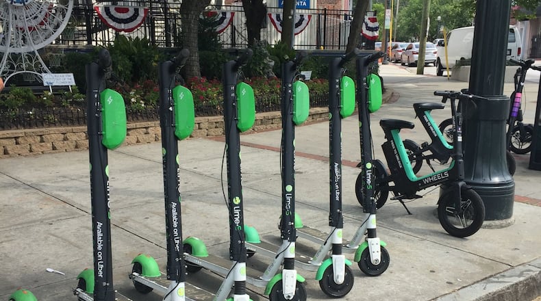 The correct way to park Scooters per Decatur’s new ordinance: They must be parked upright on hard surfaces without obstructing pedestrians or cars. Courtesy of Lime