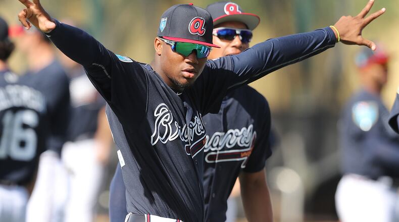 Braves top prospect outfielder Ronald Acuna takes the field to loosen up for a spring training practice in Lake Buena Vista, Fla. Acuna has been reassigned by the Braves to minor-league camp.