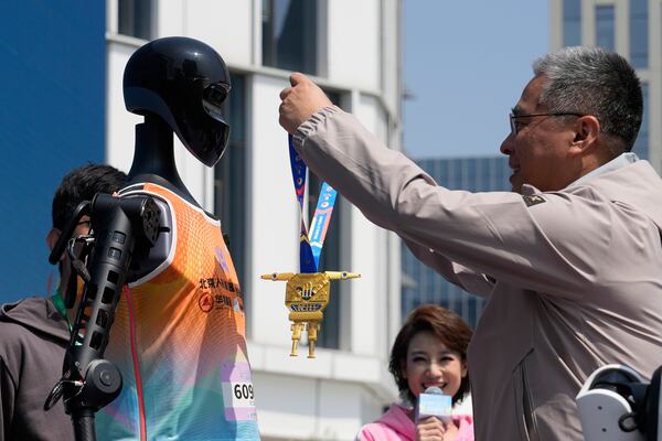 The Sky Project Ultra robot also known as Tien Kung Ultra is awarded the gold medal after winning the Humanoid Robot Half-Marathon held in Beijing on Saturday, April 19, 2025. (AP Photo/Ng Han Guan)