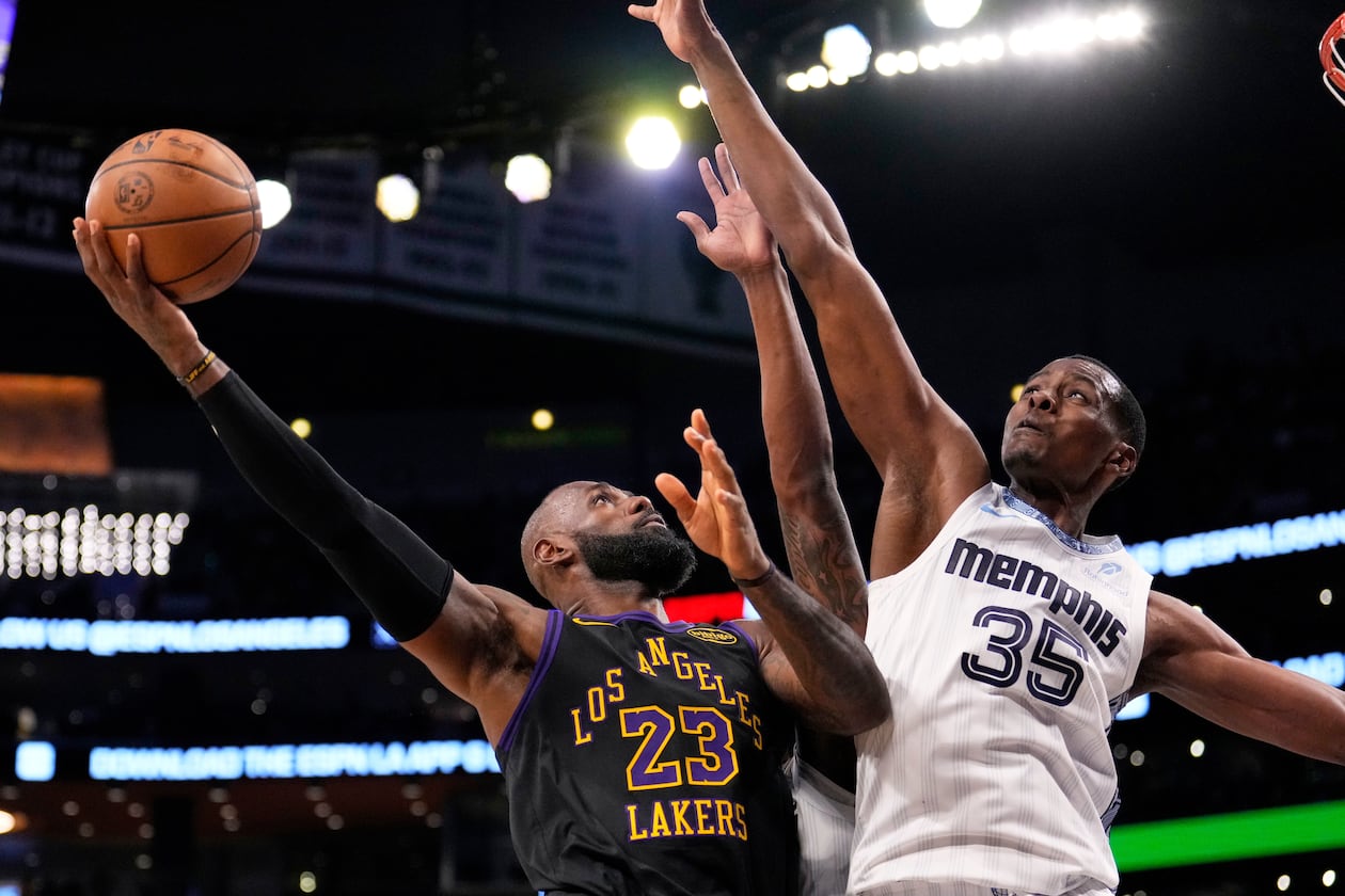Los Angeles Lakers forward LeBron James, left, shoots as Memphis Grizzlies center Christian Koloko defends during the second half of an NBA basketball game Friday, Jan. 2, 2026, in Los Angeles. (Mark J. Terrill/AP)