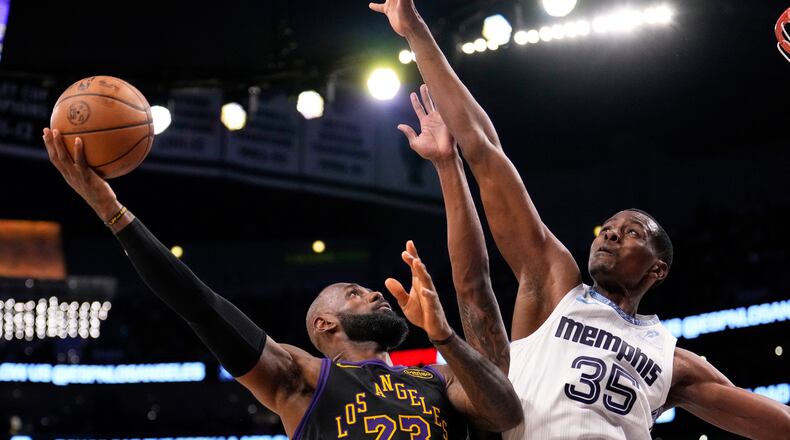 Los Angeles Lakers forward LeBron James, left, shoots as Memphis Grizzlies center Christian Koloko defends during the second half of an NBA basketball game Friday, Jan. 2, 2026, in Los Angeles. (Mark J. Terrill/AP)