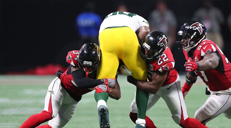 September 17, 2017 Atlanta: Falcons cornerback Brian Poole (left) and safety Keanu Neal double team Packers tight end Martellus Bennett for the stop during the second half in a NFL football game on Sunday, September 17, 2017, in Atlanta. Curtis Compton/ccompton@ajc.com
