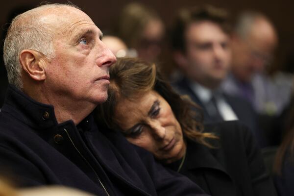 Joe Gutman looks up as his wife, Sheila Gutman, right, puts her head on his shoulder during the sentencing hearing for Robert E. Crimo III at the Lake County Courthouse, in Waukegan, Ill., Thursday, April 24, 2025. (Stacey Wescott/Chicago Tribune via AP, Pool)