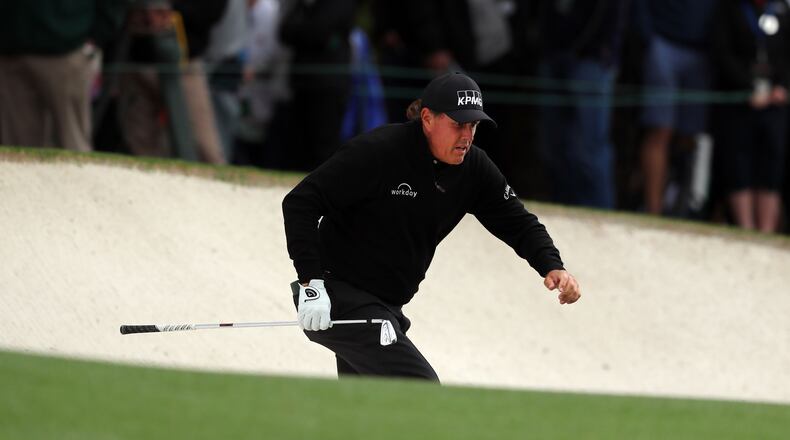 Phil Mickelson comes out of the 1st fairway bunker as play begins in the opening round of the 81st Masters tournament at the Augusta National Golf Club Thursday.