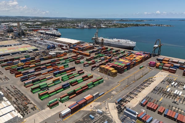 Tractor trailers and containers fill a shipping yard at the San Juan port in Puerto Rico, Thursday, May 8, 2025. (AP Photo/Alejandro Granadillo)