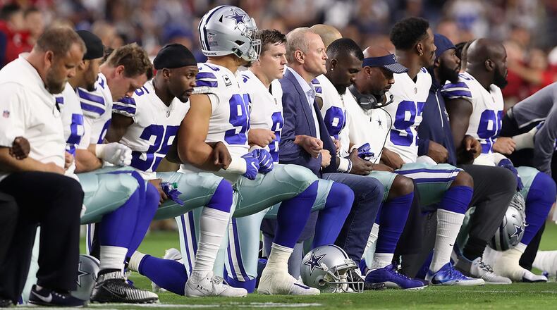 GLENDALE, AZ - SEPTEMBER 25: Members of the Dallas Cowboys link arms before the National Anthem at the start of the NFL game against the Arizona Cardinals at the University of Phoenix Stadium on September 25, 2017 in Glendale, Arizona. (Photo by Christian Petersen/Getty Images)