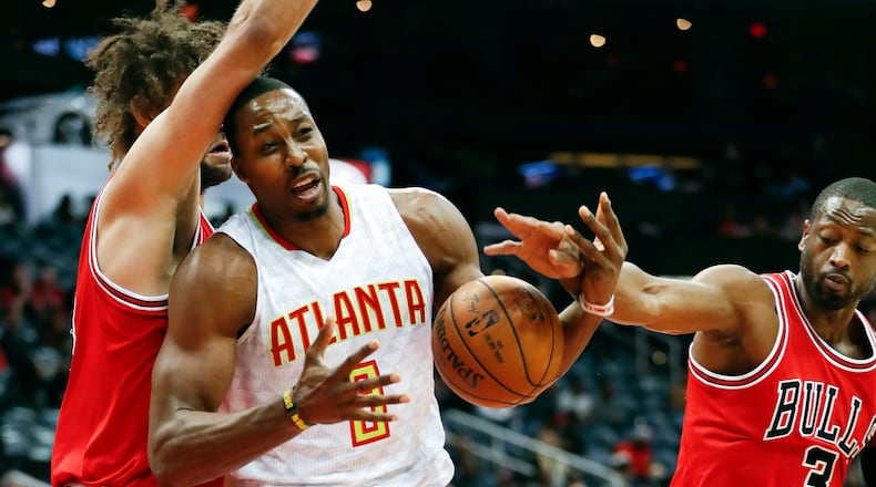 Atlanta Hawks center Dwight Howard (8) works against Chicago Bulls guard Dwyane Wade (3) and center Robin Lopez for the ball during the first half of an NBA basketball game Wednesday, Nov. 9, 2016, in Atlanta. (AP Photo/John Bazemore)