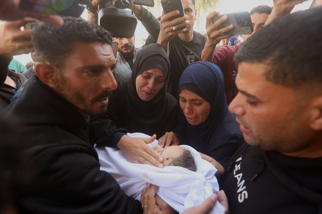 Palestinians mourn over an Al-Tanani family member, killed in an Israeli strike, during their funeral at Al-Shifa Hospital in Gaza City, Saturday, April 25, 2026. (AP Photo/Yousef Alzanoun)