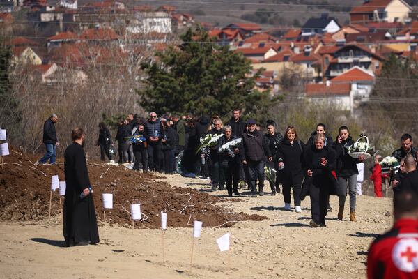 People gather at a cemetery for the funeral ceremony of the victims of a massive nightclub fire in the town of Kocani, North Macedonia, Thursday, March 20, 2025. (AP Photo/Armin Durgut)