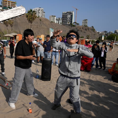 Young men dressed as “Mr. Chainsaw” and “Maduro” face off in an aura-farming battle at Las Sombrillas beach in Lima, Peru, Saturday, Aug. 29, 2026. (AP Photo/Martin Mejia)