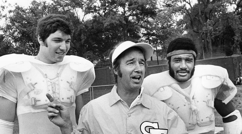 Georgia Tech coach Pepper Rodgers (middle) stands with players Billy Shields (left) and Joe Harris (right) at practice in 1974. (Billy Downs / AJC)