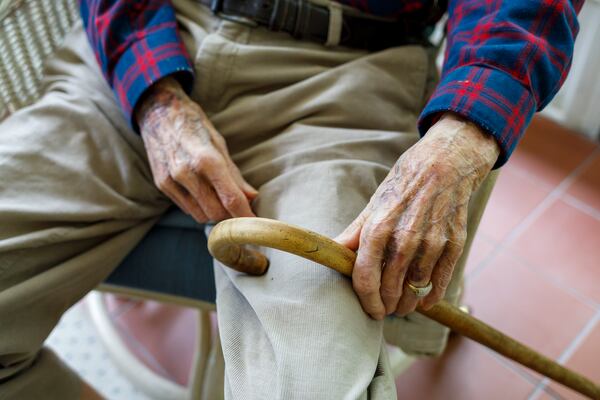 Avery Low, 104, rests his hands on a cane while seated at his home on Tuesday, May 26, 2026, in Savannah. After returning from World War II, Low attended Georgia Tech, raised nine children and worked with Atlantic Coastline Railroad for 40 years. (Walker Smith for the AJC)