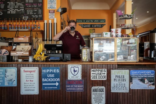 Calistoga Roastery owner Clive Richardson sips coffee behind the counter Tuesday, May 27, 2025, in Calistoga, Calif. (AP Photo/Annika Hammerschlag)