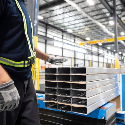 FILE - Workers prepare extruded aluminum product for packaging at Magna Aluminum Profile's fully electric powered extrusion facility in Salaberry-de-Valleyfield, Quebec, Canada, on Sept. 3, 2025. (Christopher Katsarov/The Canadian Press via AP, File)