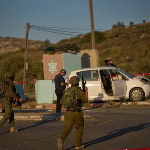 Israeli security forces inspect the scene where, according to police, a Palestinian man was shot and killed after ramming his car into a security checkpoint and seriously wounding an officer, near the West Bank Jewish settlement of Beit Horon, Wednesday, Sept. 23, 2026.(AP Photo/Ohad Zwigenberg)