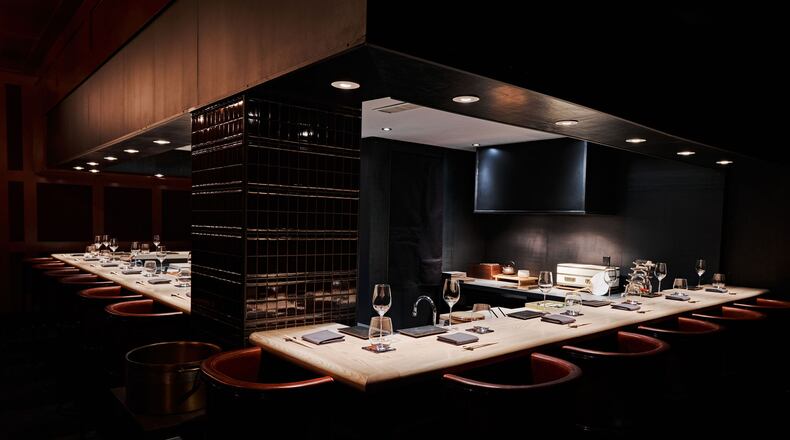 The black-walled, windowless dining room at Mujo offers ambience to rival its food. (Courtesy of Mujo)