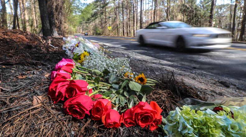 Flowers lay on the side of Robinson Road in Peachtree City on Monday, March 22, 2021, where a 19-year-old driver and 16-year-old passenger were killed Saturday. (John Spink / John.Spink@ajc.com)