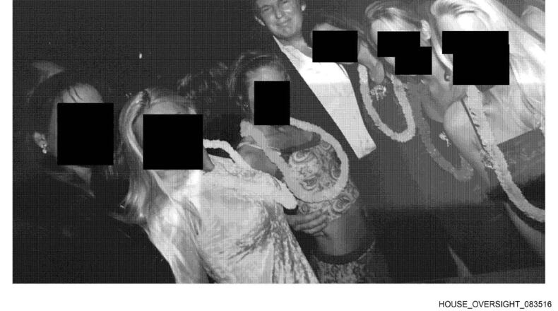 This undated, redacted photo released by Democrats on the House Oversight Committee shows Donald Trump standing with a group of women. (House Oversight Committee via AP)