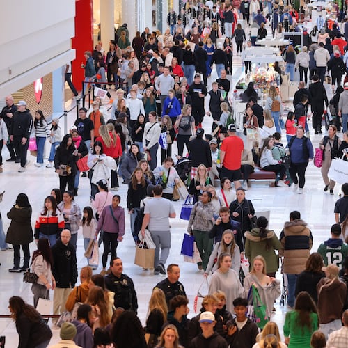 Shoppers browse through stores at Mall of America for Black Friday deals, Friday, Nov. 28, 2025, in Bloomington, Minn. (AP Photo/Adam Bettcher)