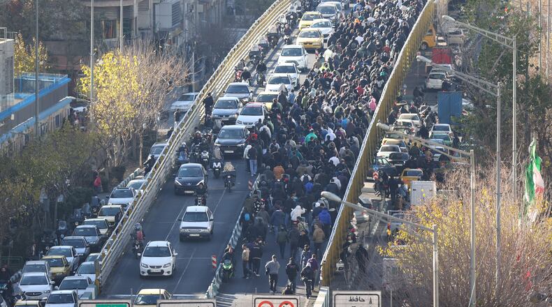 Protesters march in downtown Tehran, Iran, Monday, Dec. 29, 2025. (Fars News Agency via AP)