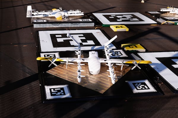 A Wing delivery drone charges on a pad at a Walmart Supercenter in Woodstock on Dec. 3, 2025. (Natrice Miller/AJC)