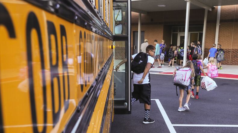 Cobb County schools started back to school Monday. In this photo, students arrive for class at Mountain View Elementary School on Sandy Plains Road in Cobb County. JOHN SPINK / JSPINK@AJC.COM.