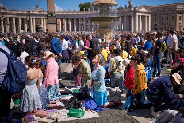 Faithful pray during the funeral of Pope Francis in St. Peter's Square at the Vatican, Saturday, April 26, 2025. (AP Photo/Emilio Morenatti)