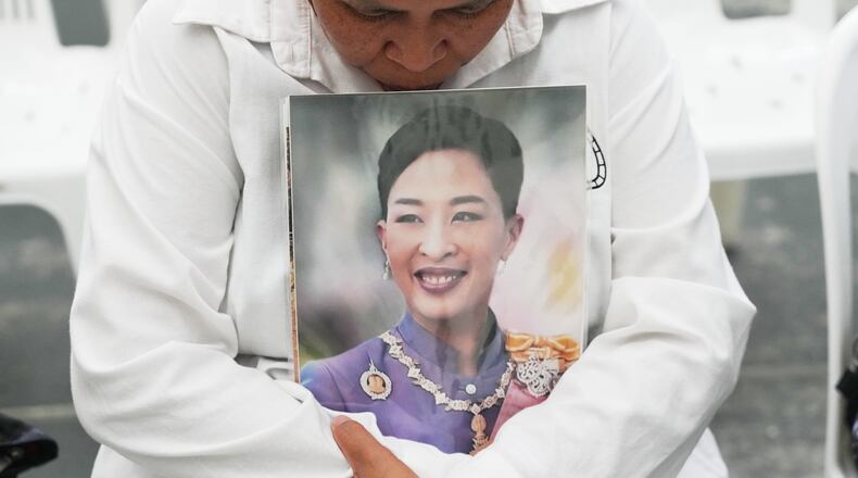 A person holds a picture of the late Thailand Princess Bajrakitiyabha Mahidol in Bangkok, Thailand, Friday, June 12, 2026. (AP Photo/Sakchai Lalit)