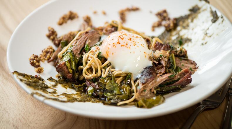 Cast Iron’s rye spaghetti with pork shoulder, collard greens, poached egg, mustard seeds and burnt onion is better some times than others. CONTRIBUTED BY MIA YAKEL